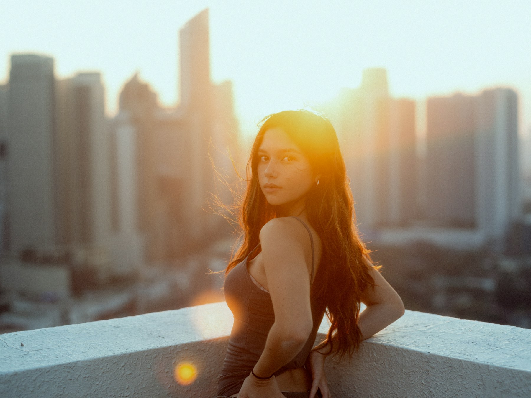 A woman at sunset above the city
