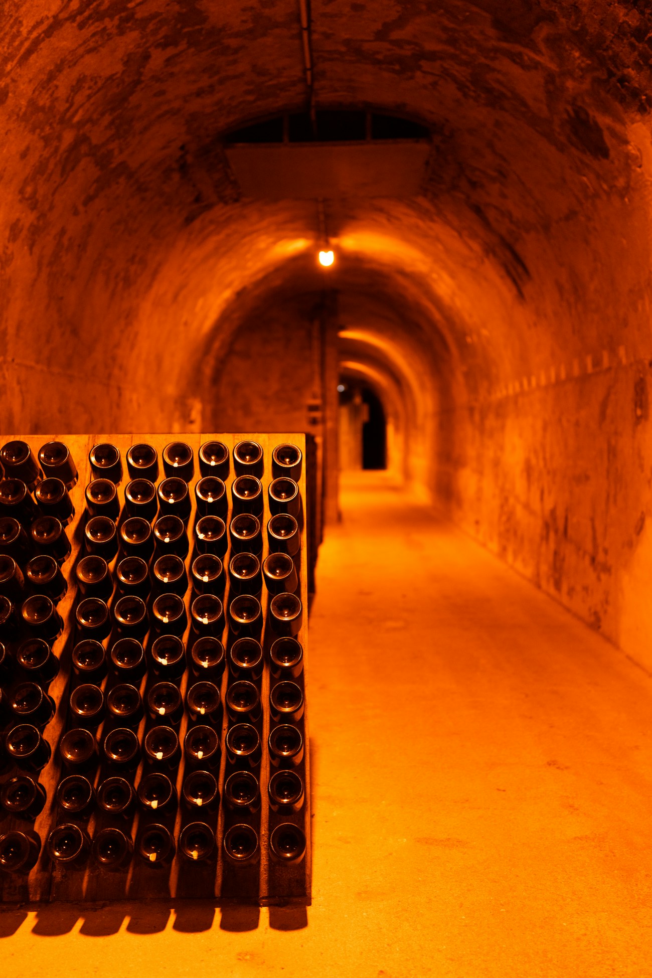 A candle-lit tunnel of old bottles