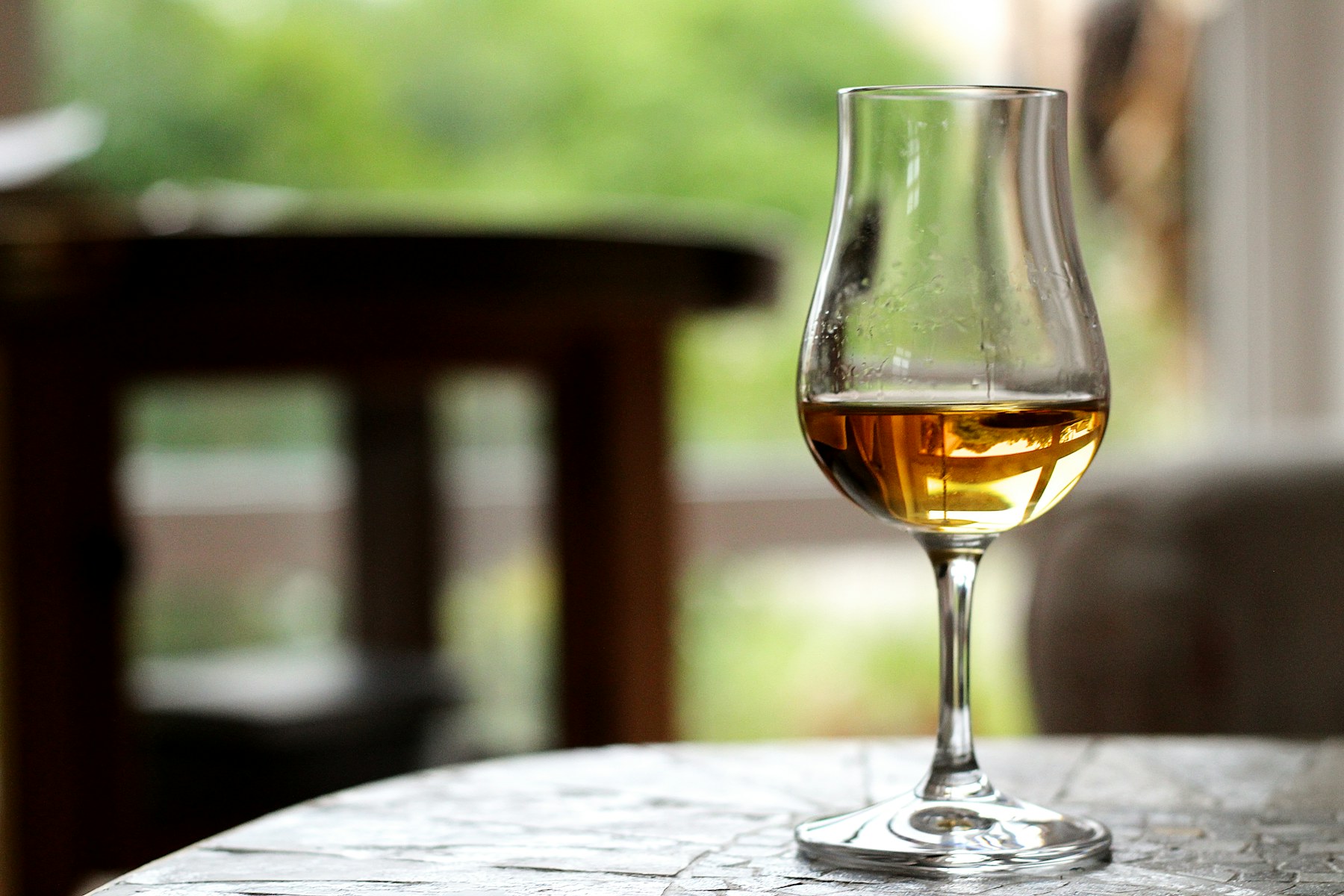 A tulip glass of cognac on a café table