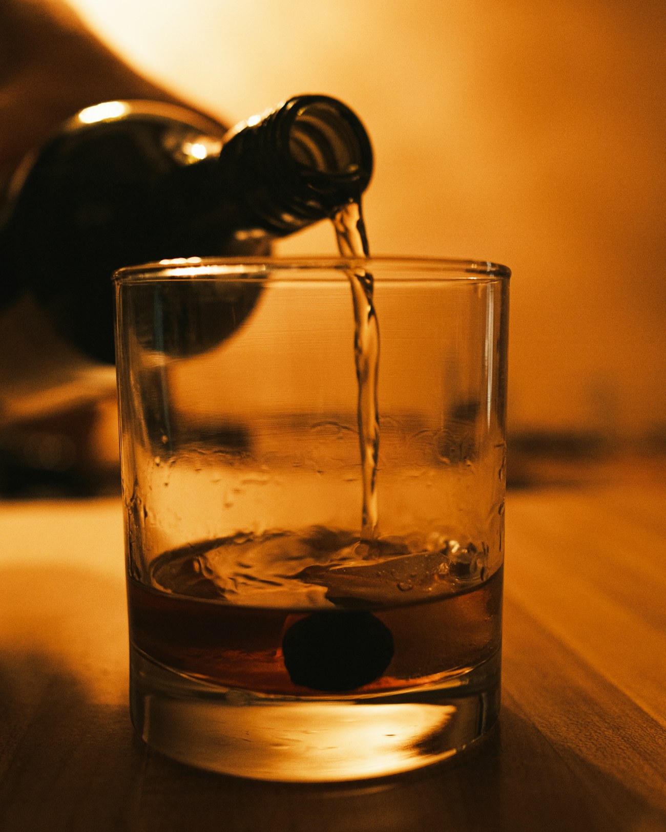 Cognac poured into a glass in warm light