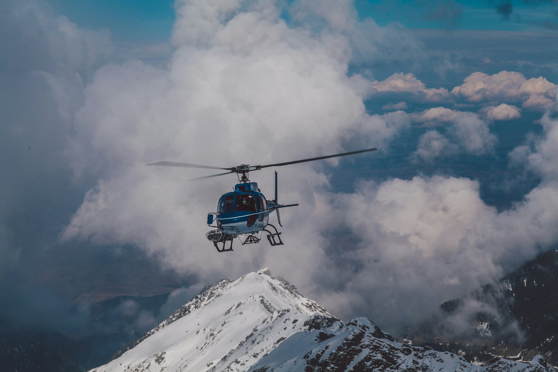 A helicopter above the clouds