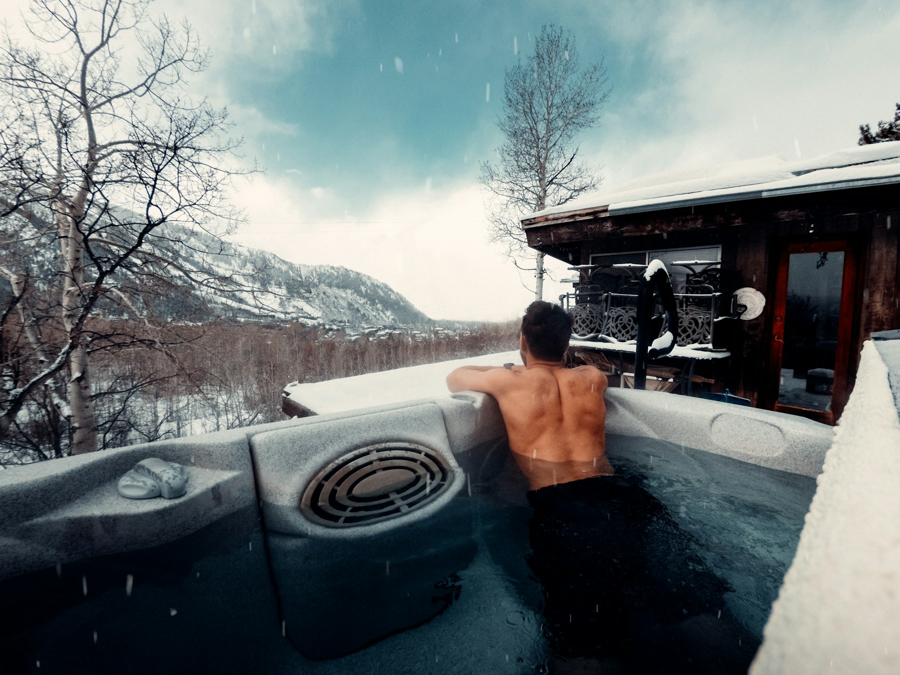 A hot tub in the snow at dusk