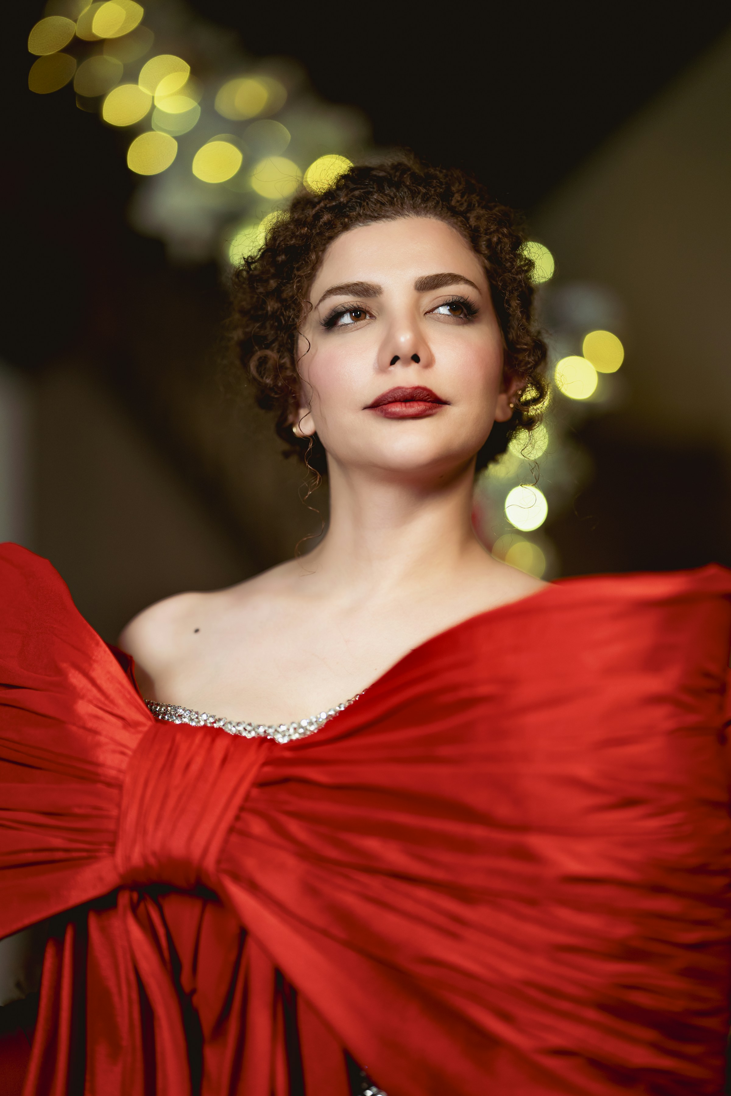 Woman in a red gown wearing diamonds