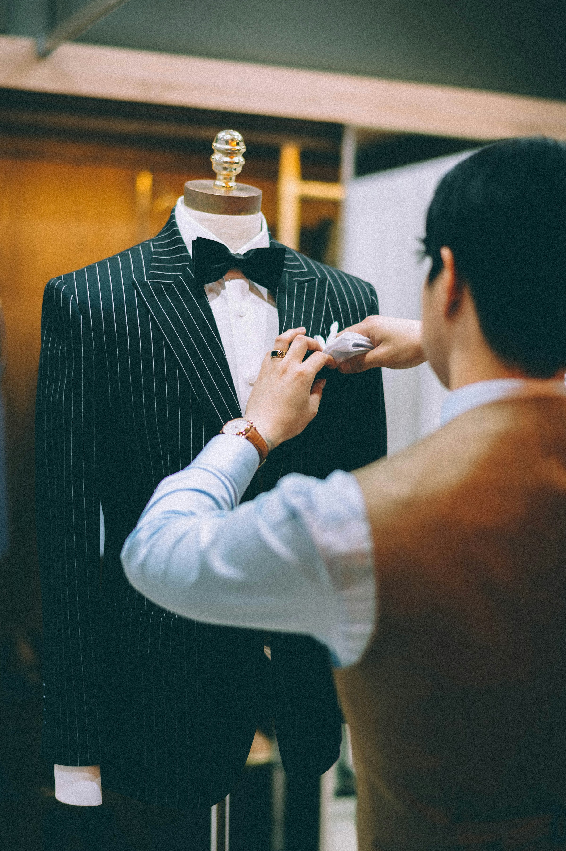 Cutter fitting a pinstripe jacket on the stand