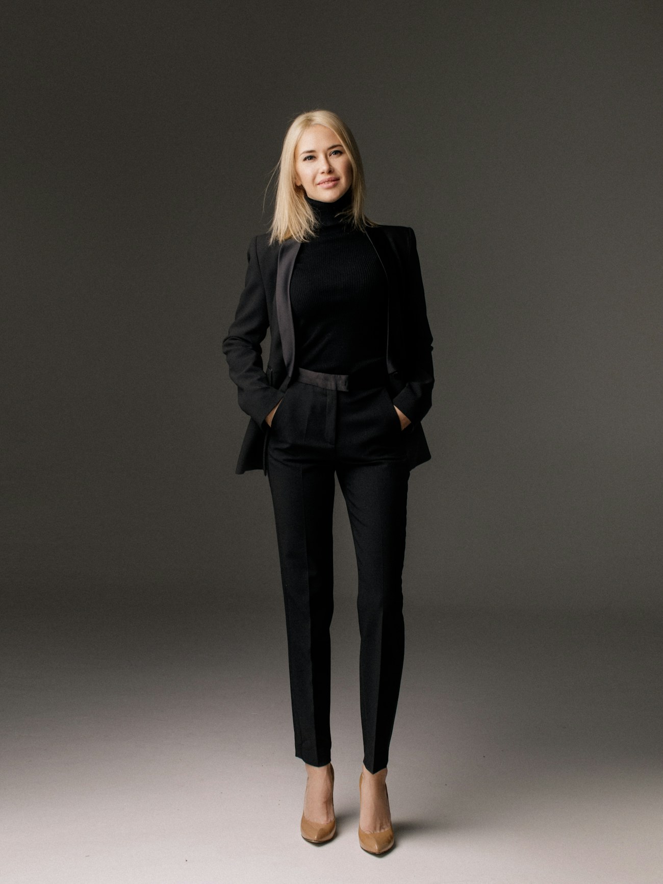 Woman in a black bespoke trouser suit
