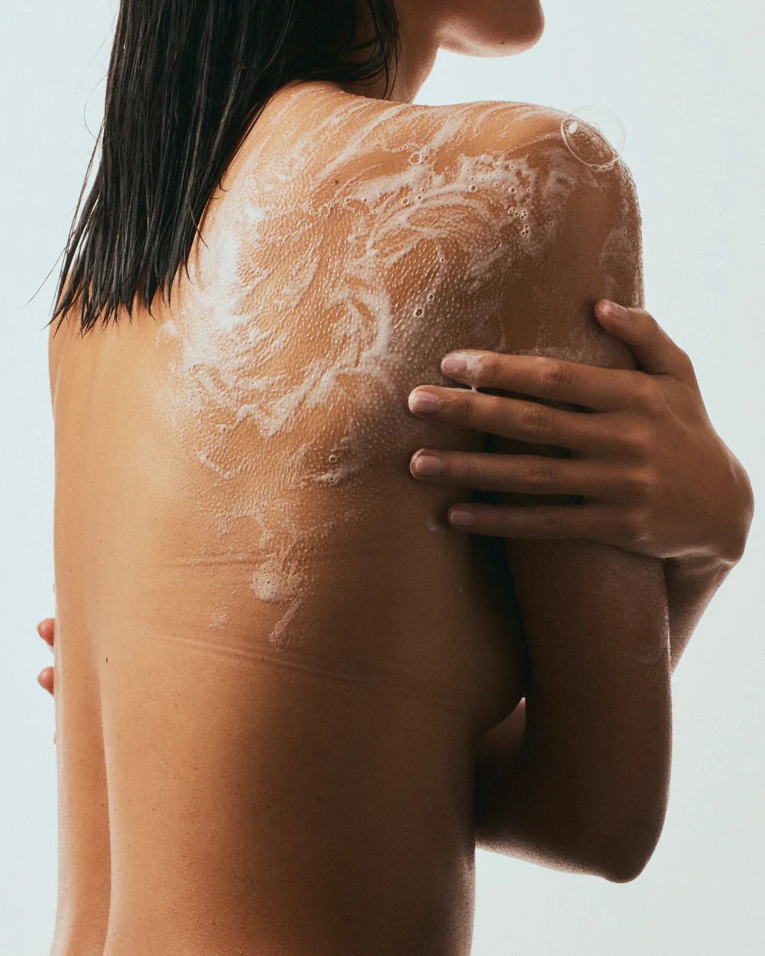 Body wash lathered across a shoulder