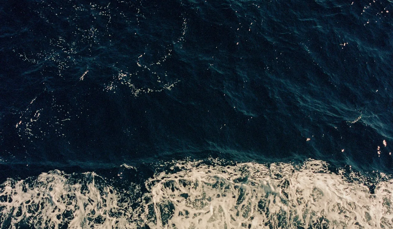 Surf breaking over deep water