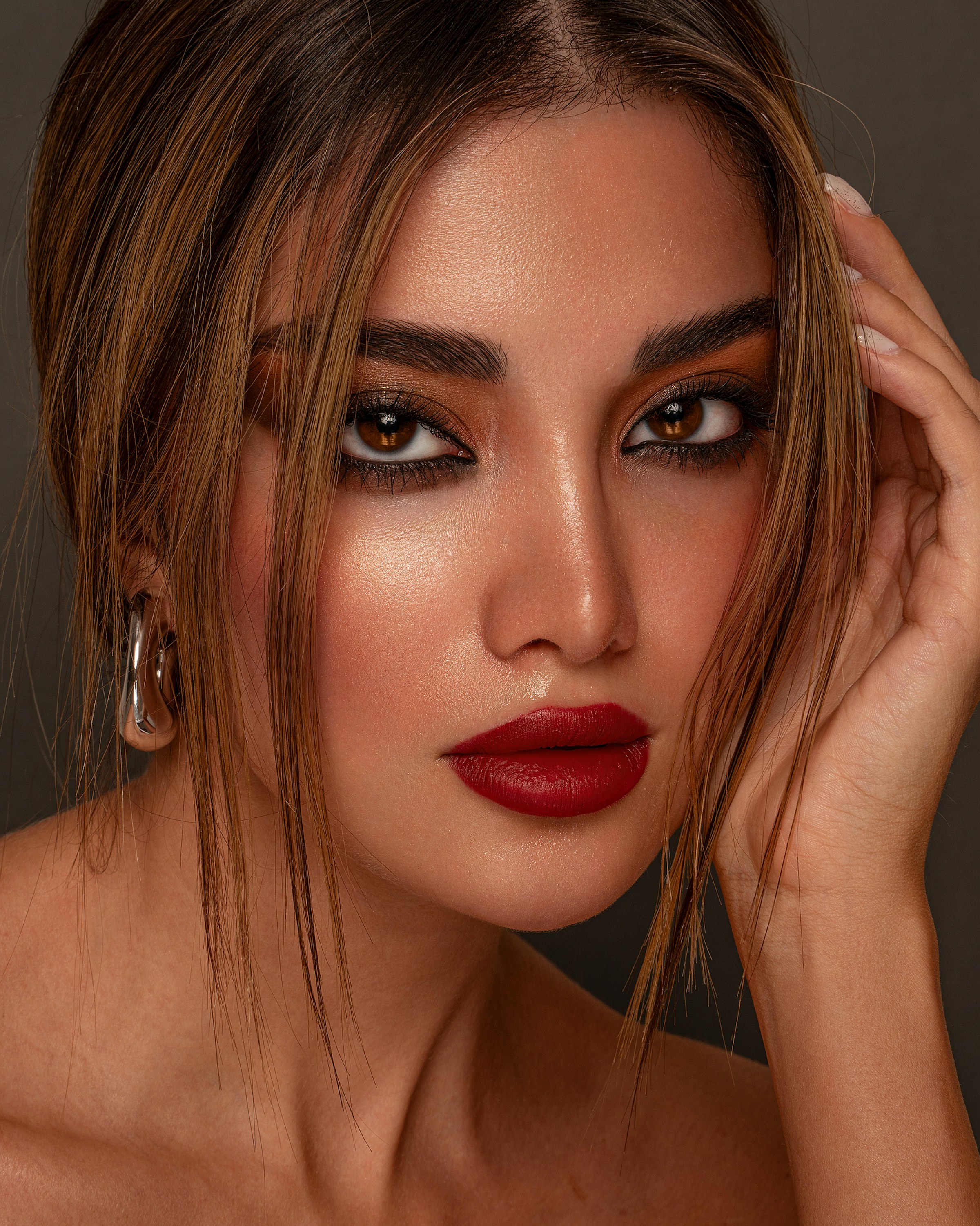 Model with luminous, glowing skin and a red lip