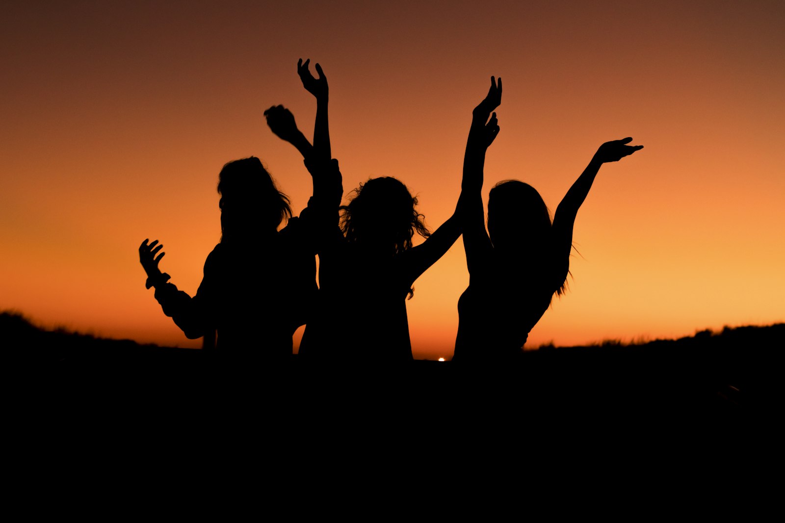 Friends dancing on the beach