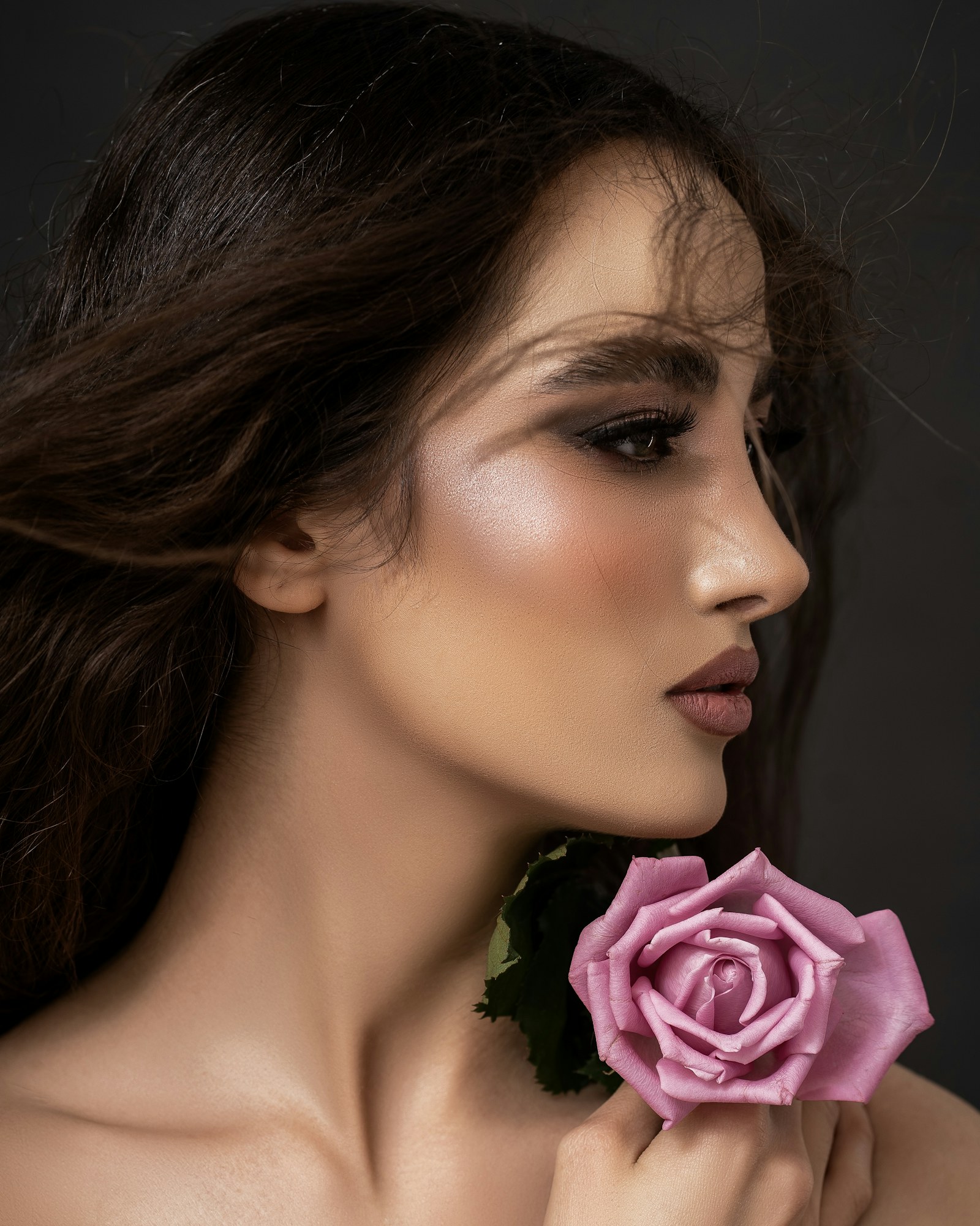 Model holding a pink rose