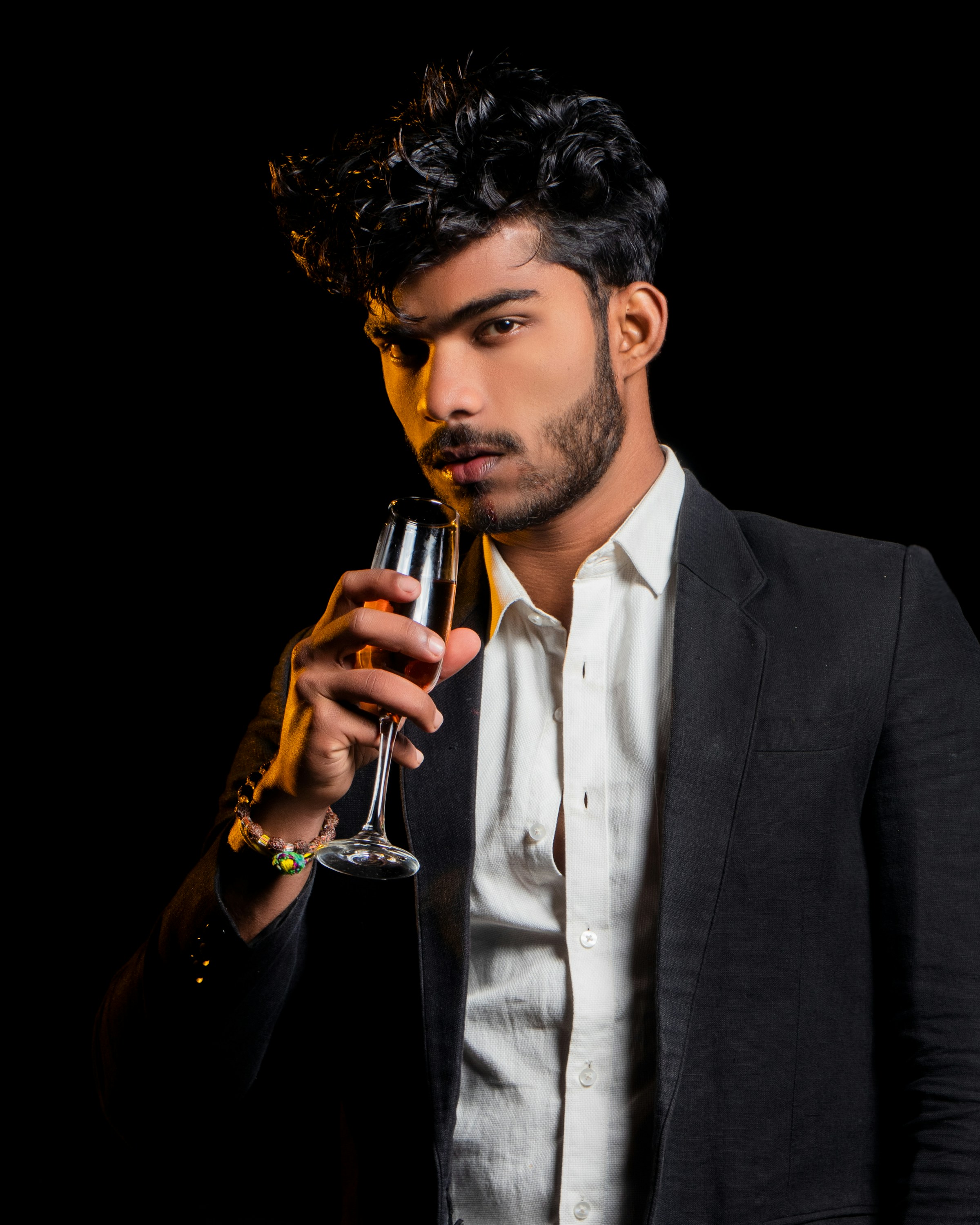 Man in a black suit with champagne
