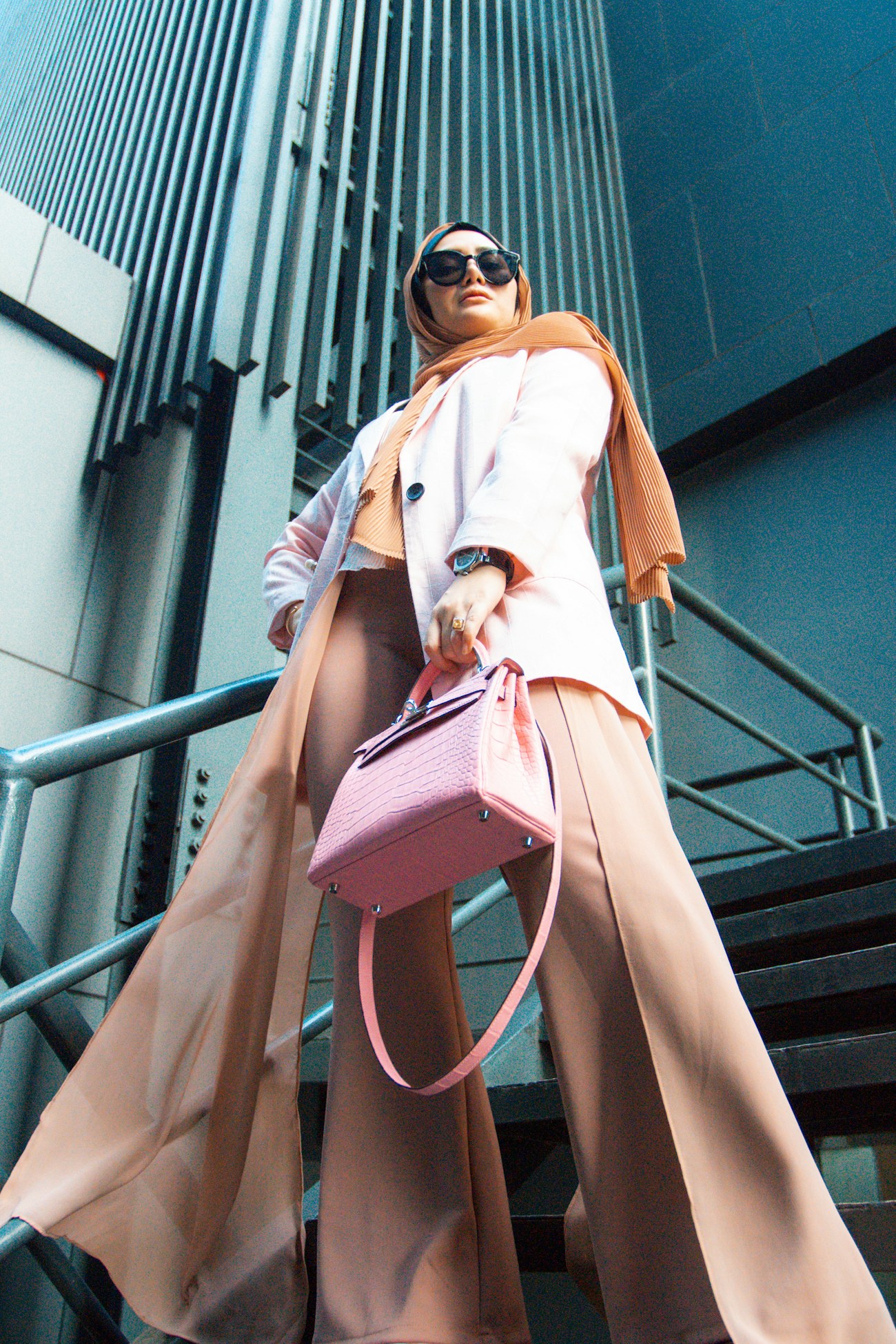 A woman carrying a VELLUM bag