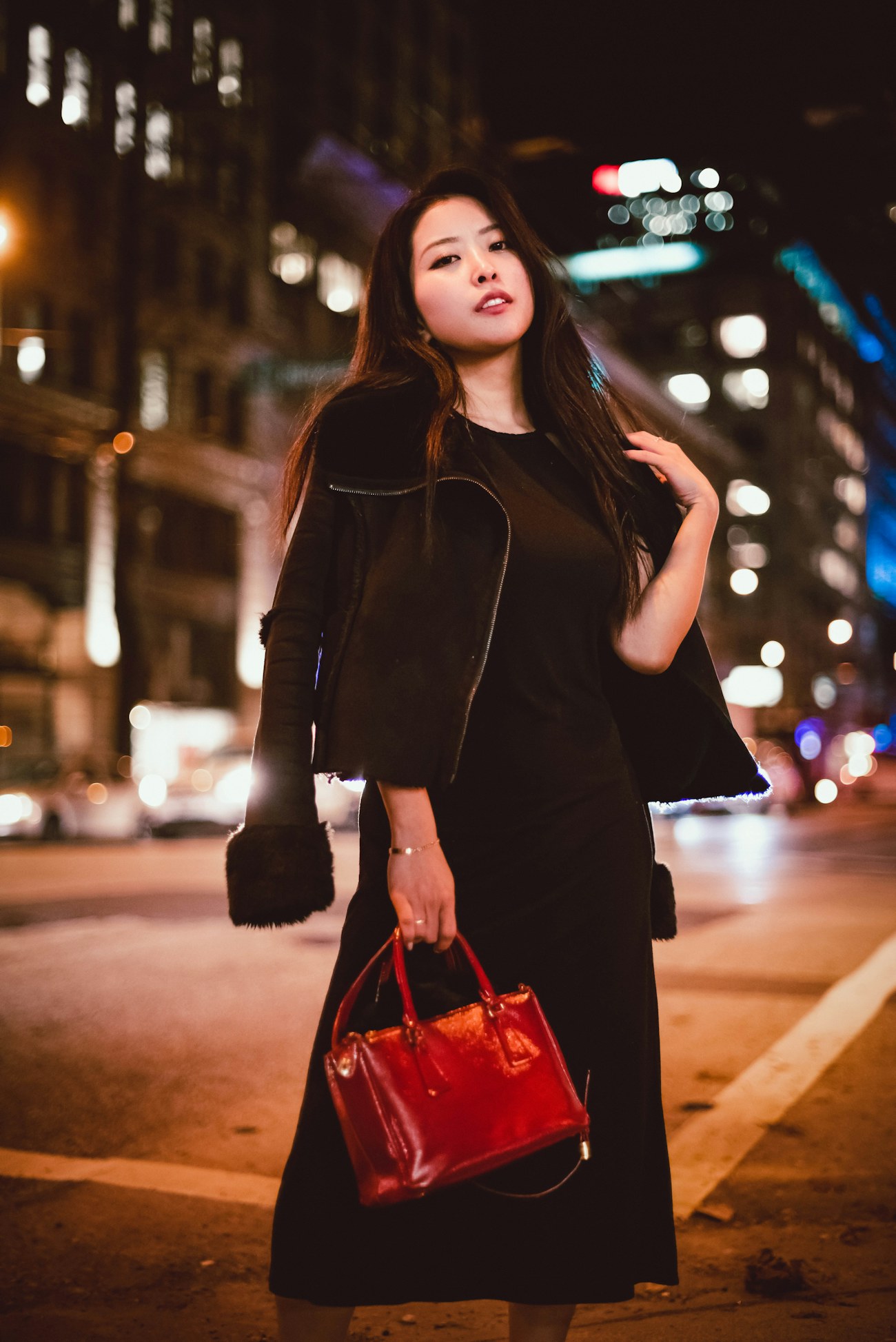 A woman carrying a VELLUM bag