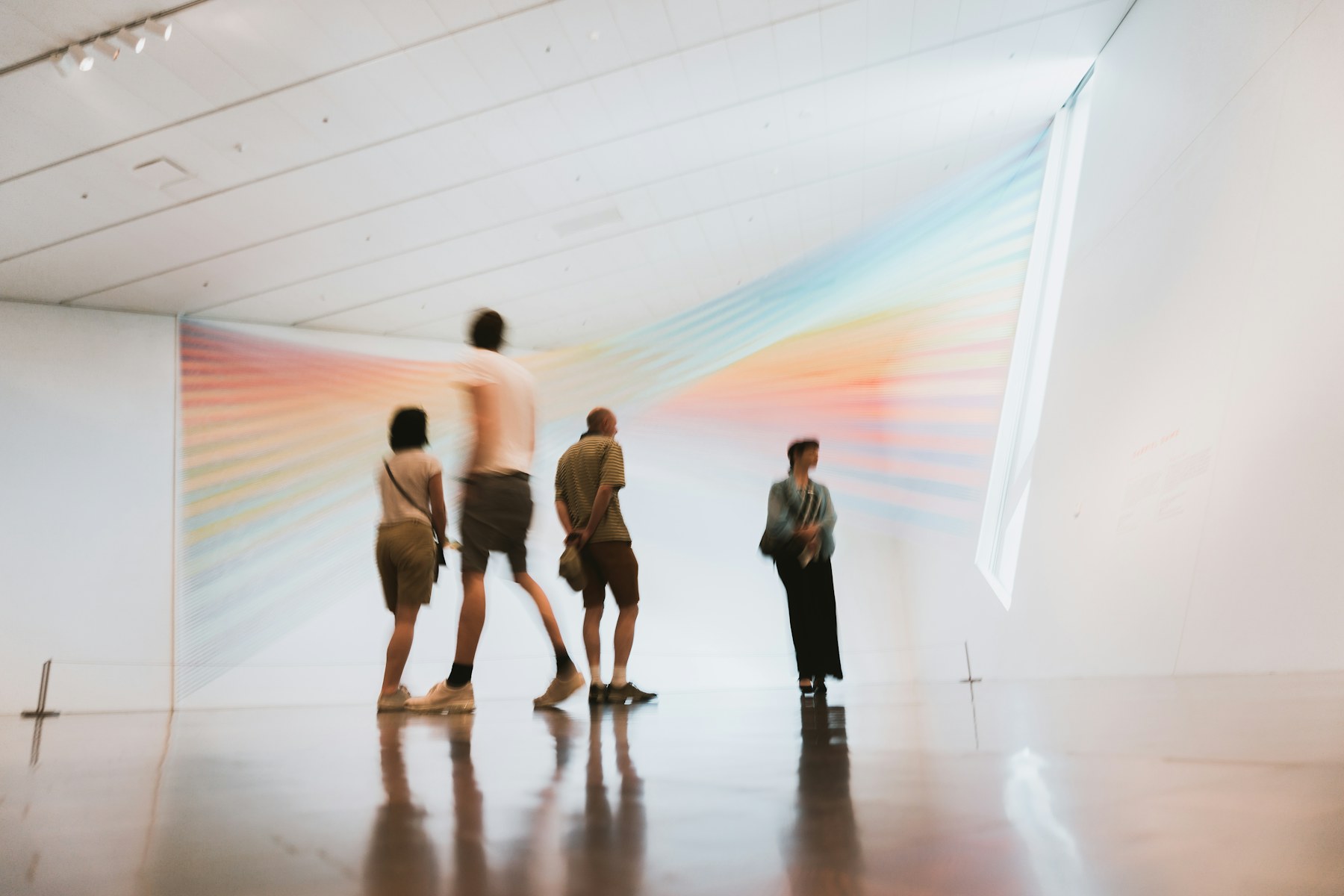 Visitors walking through a light installation