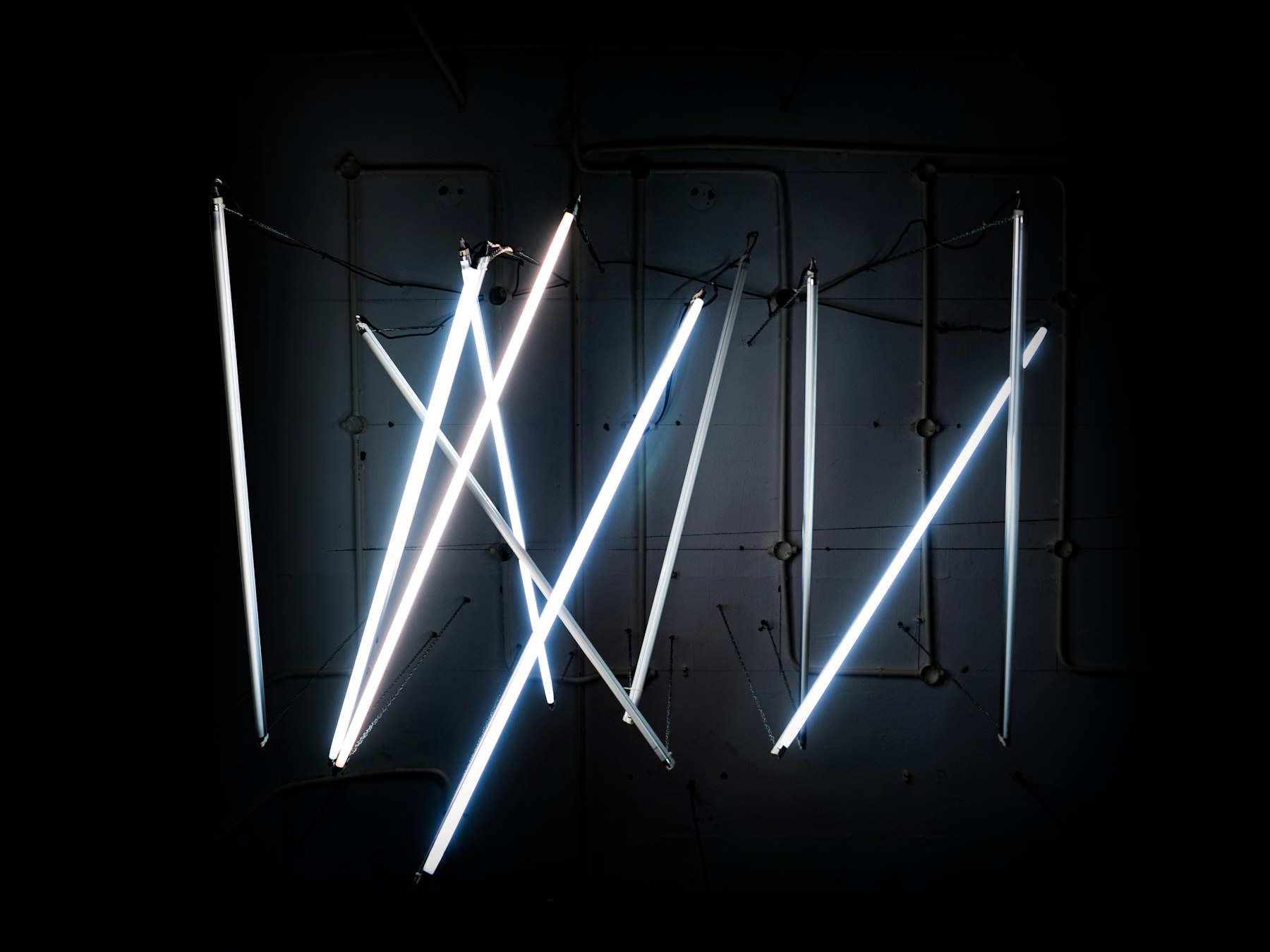 A neon light installation in a dark room